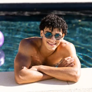 man-sunglasses-smiling-at-pool-edge